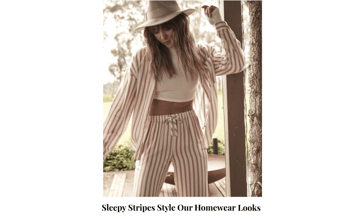 Woman in striped Gingerlilly Sleepwear set and hat, standing outdoors in natural light