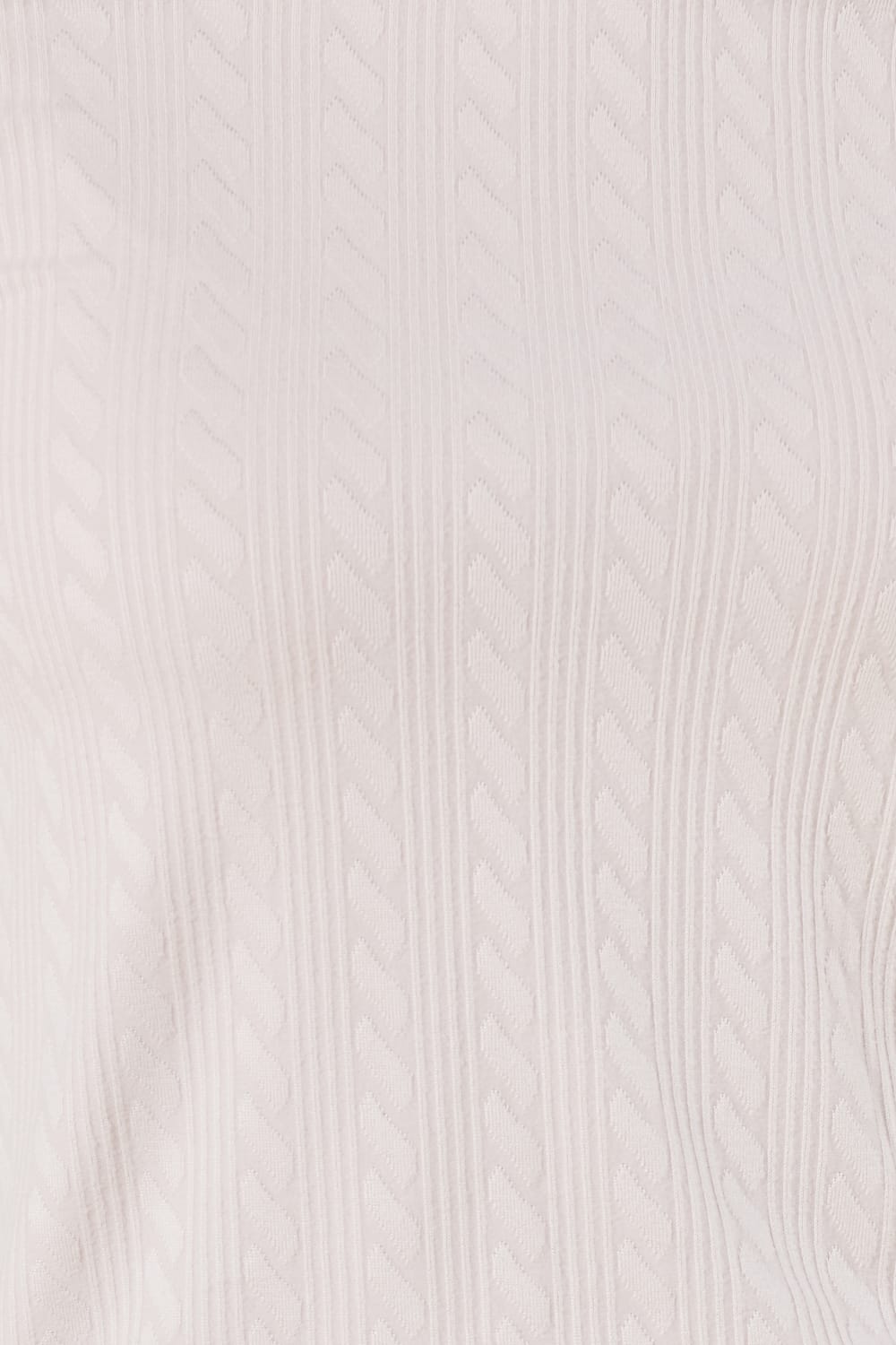 Close-up of a pink textured fabric of the ellie lightweight velour cable knit showing the pattern