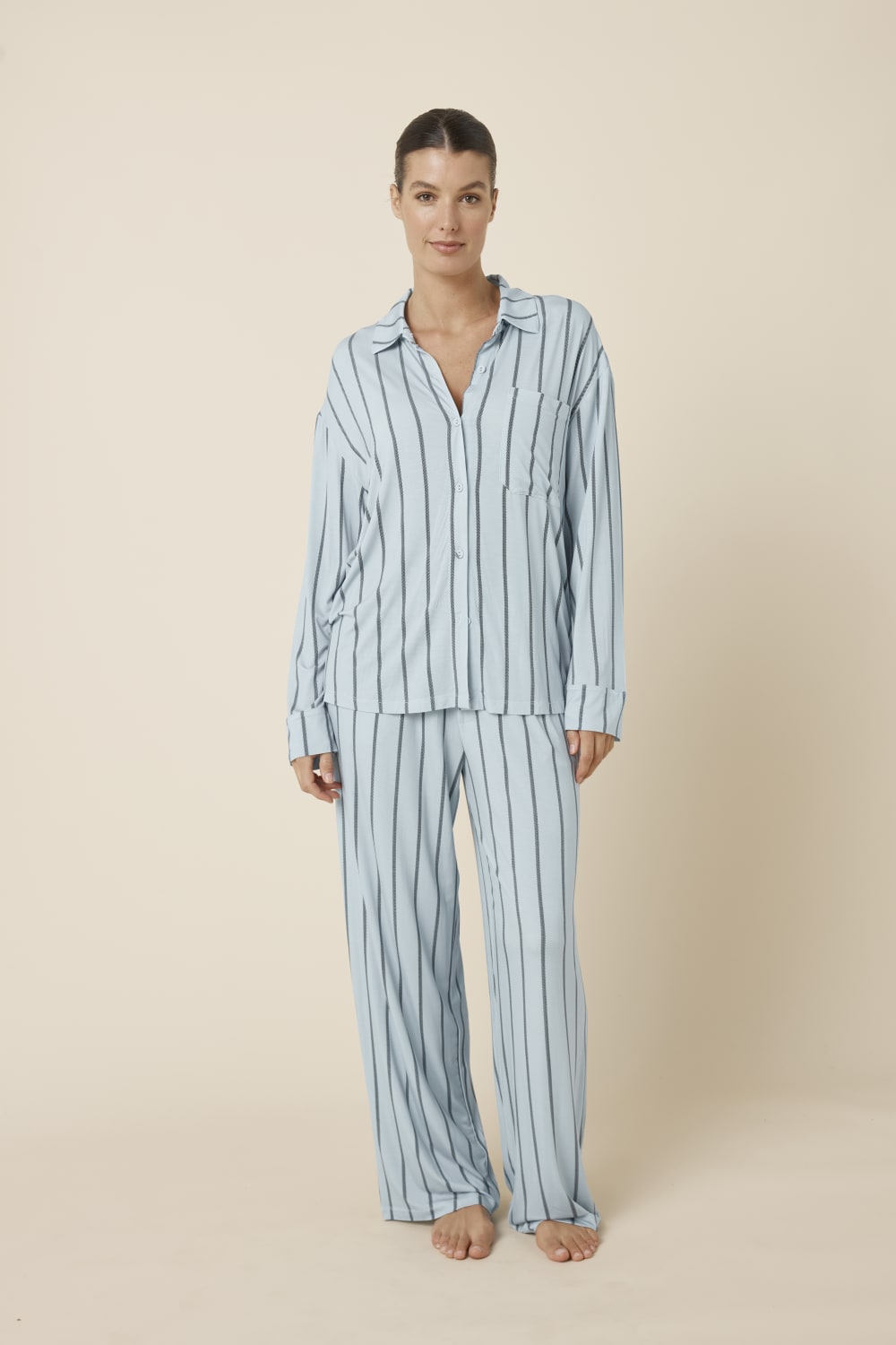 Woman wearing a light blue Harlow Bamboo Striped PJ Set from a front on view