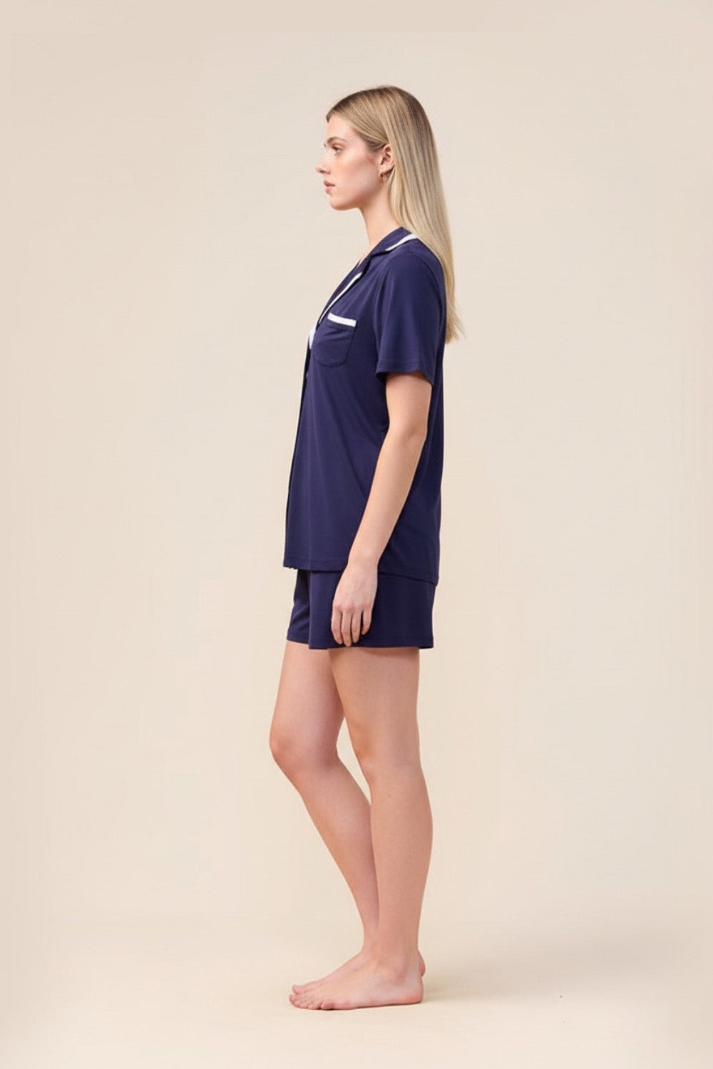 Woman wearing the Allegra Short Bamboo PJ Set in Navy, side view showing white contrast trim