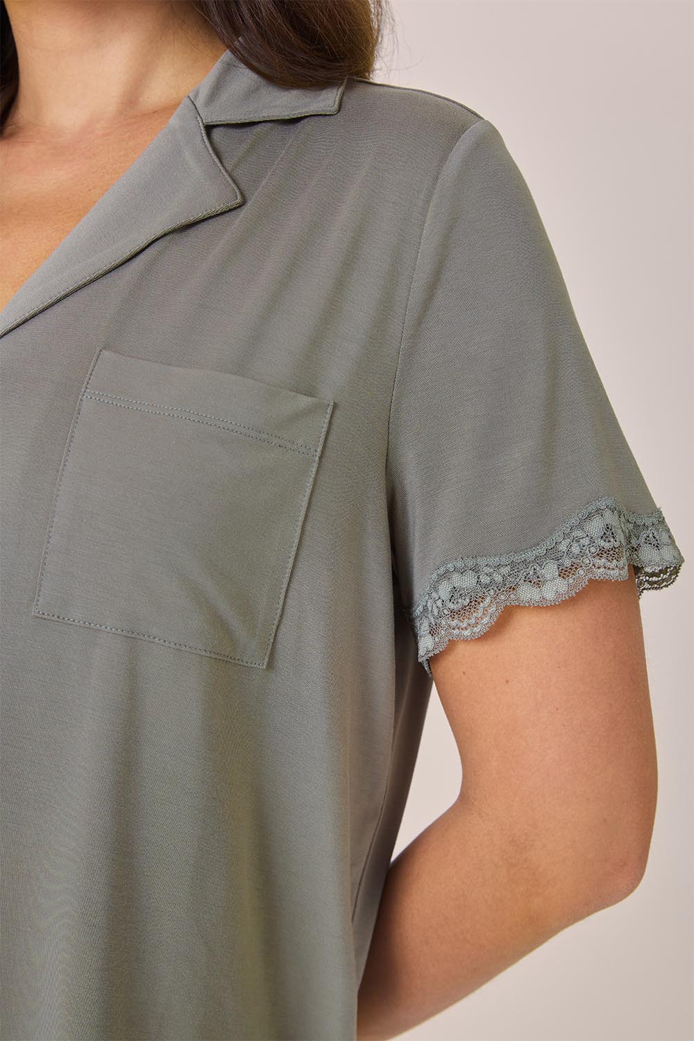 Close-up of the Joni Bamboo Short Set with Lace in Olive, showing the chest pocket and lace-trimmed sleeve
