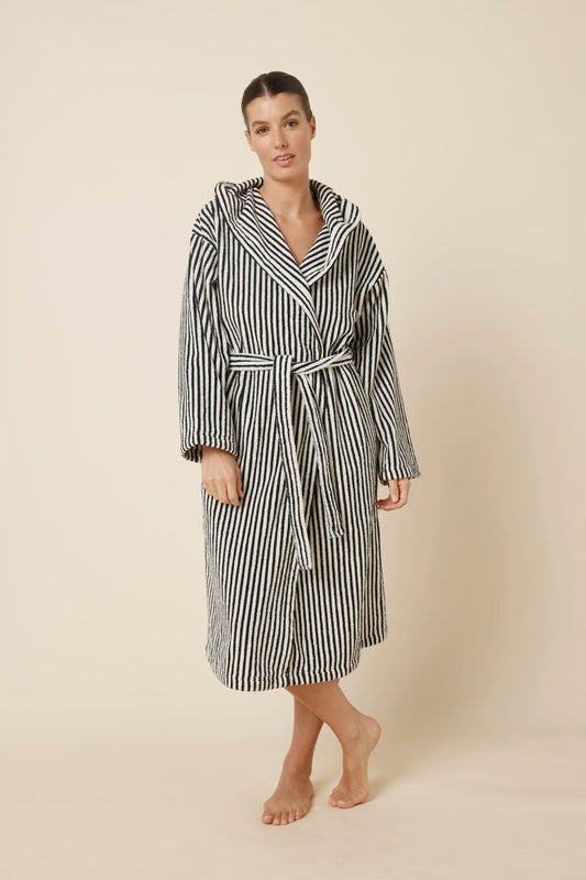 Woman wearing a striped adriana terry towel robe in black colour front on view standing with legs crossed