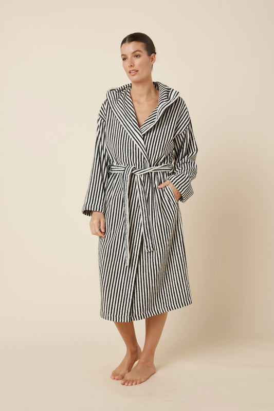 Woman wearing a striped adriana terry towel robe in black colour side on view standing