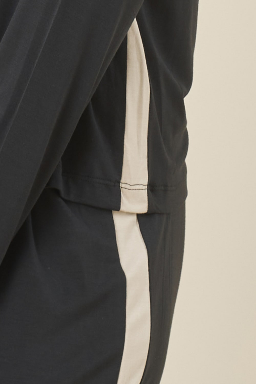 Close up of Anya Bamboo Sporty PJ Set Black pants showing the contrast satin side stripe detail running along the leg.