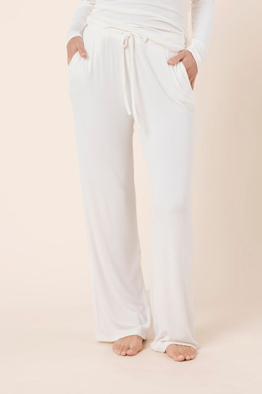 Woman wearing Athens Ribbed Long Pants Ivory, full length view of lightweight ribbed lounge pants with wide leg silhouette