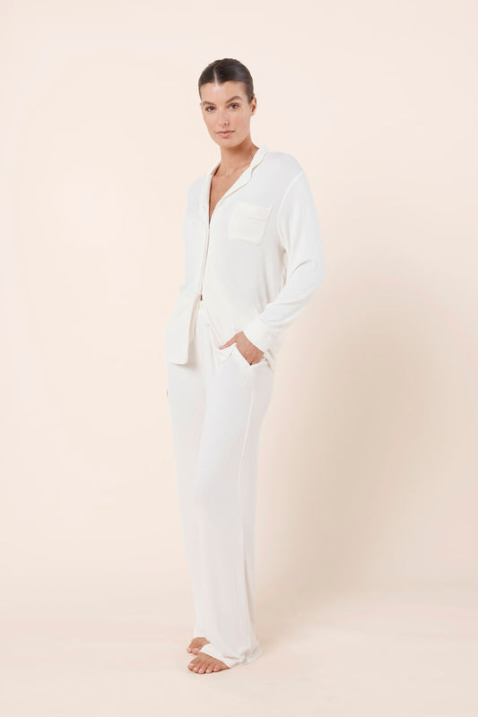 Woman wearing Athens Ribbed Long Pants Ivory styled with matching ribbed lounge top