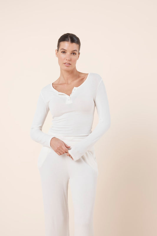 Woman wearing Athens Ribbed Long Pants Ivory with matching ribbed long sleeve lounge top