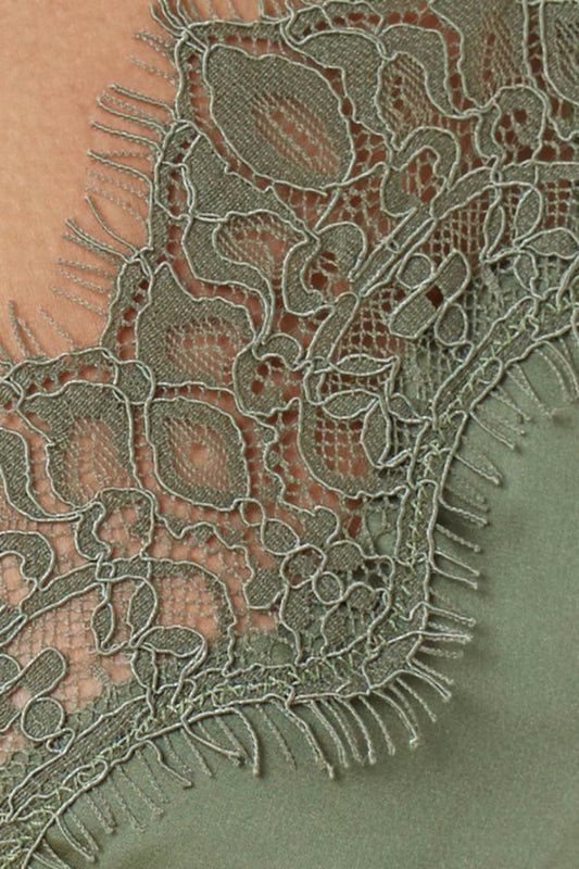 Close up of Azalia Silky Satin Short Chemise Olive lace hem detail showing delicate lace trim layered over the smooth olive satin fabric.