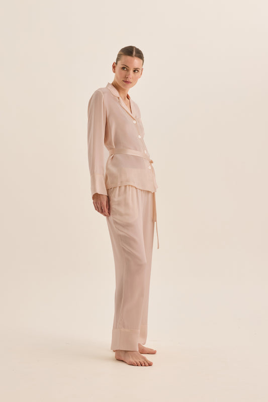 Woman wearing Gingerlilly Sleepwear ivory pajama set made from natural fabric, side view
