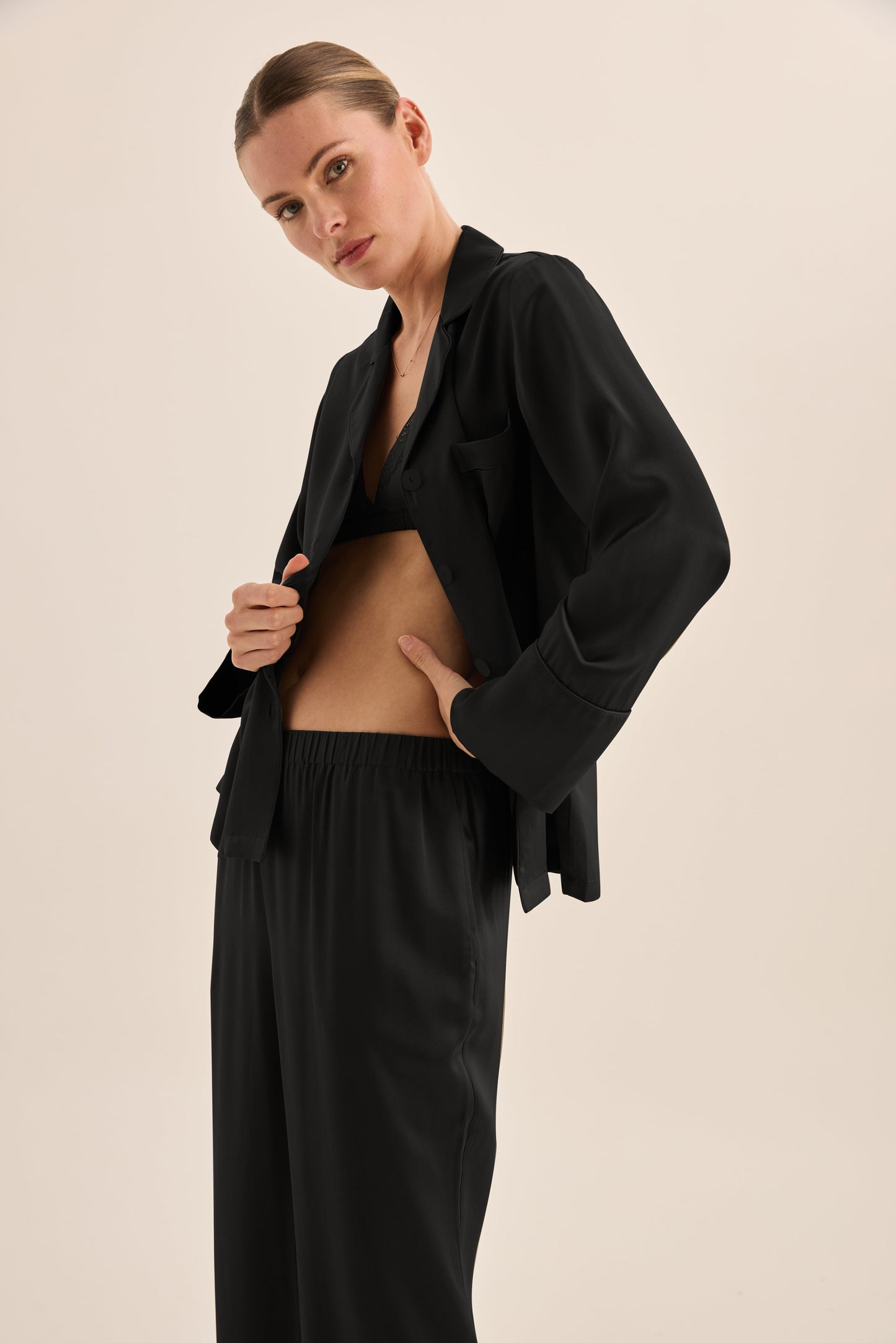 Woman wearing Gingerlilly Sleepwear black pajama set with relaxed fit, side close-up