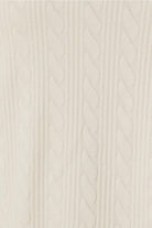 Close-up of a ivory textured fabric of the ellie lightweight velour cable knit showing the pattern
