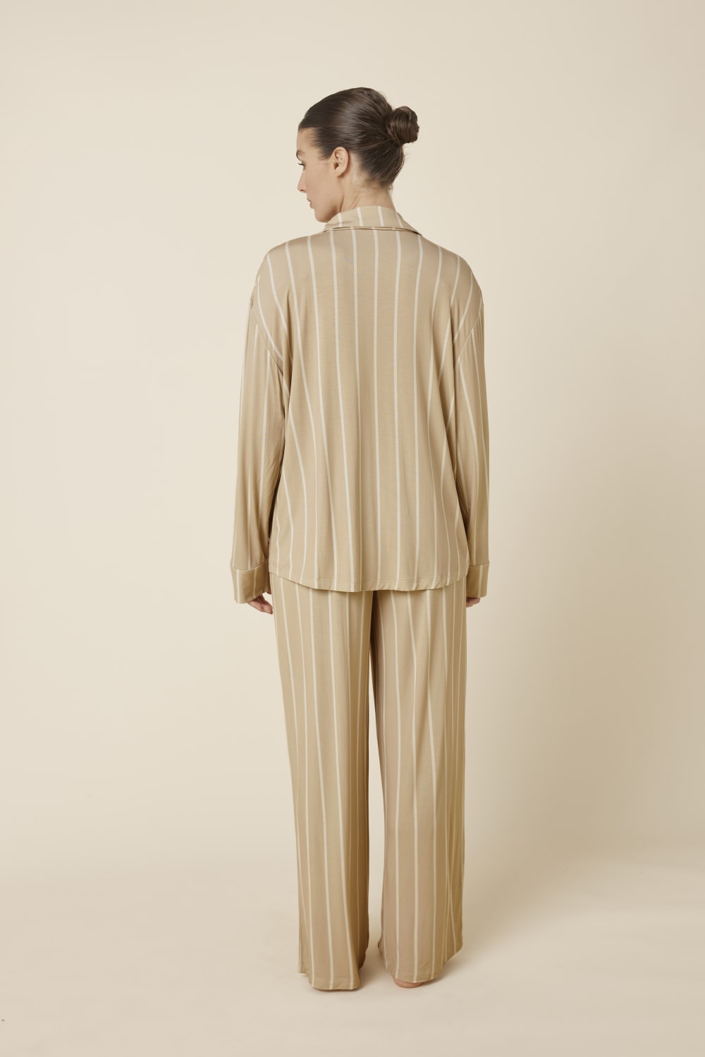 Woman wearing a Harlow Bamboo Striped pyjama PJ Set biscuit colour taken from the back view