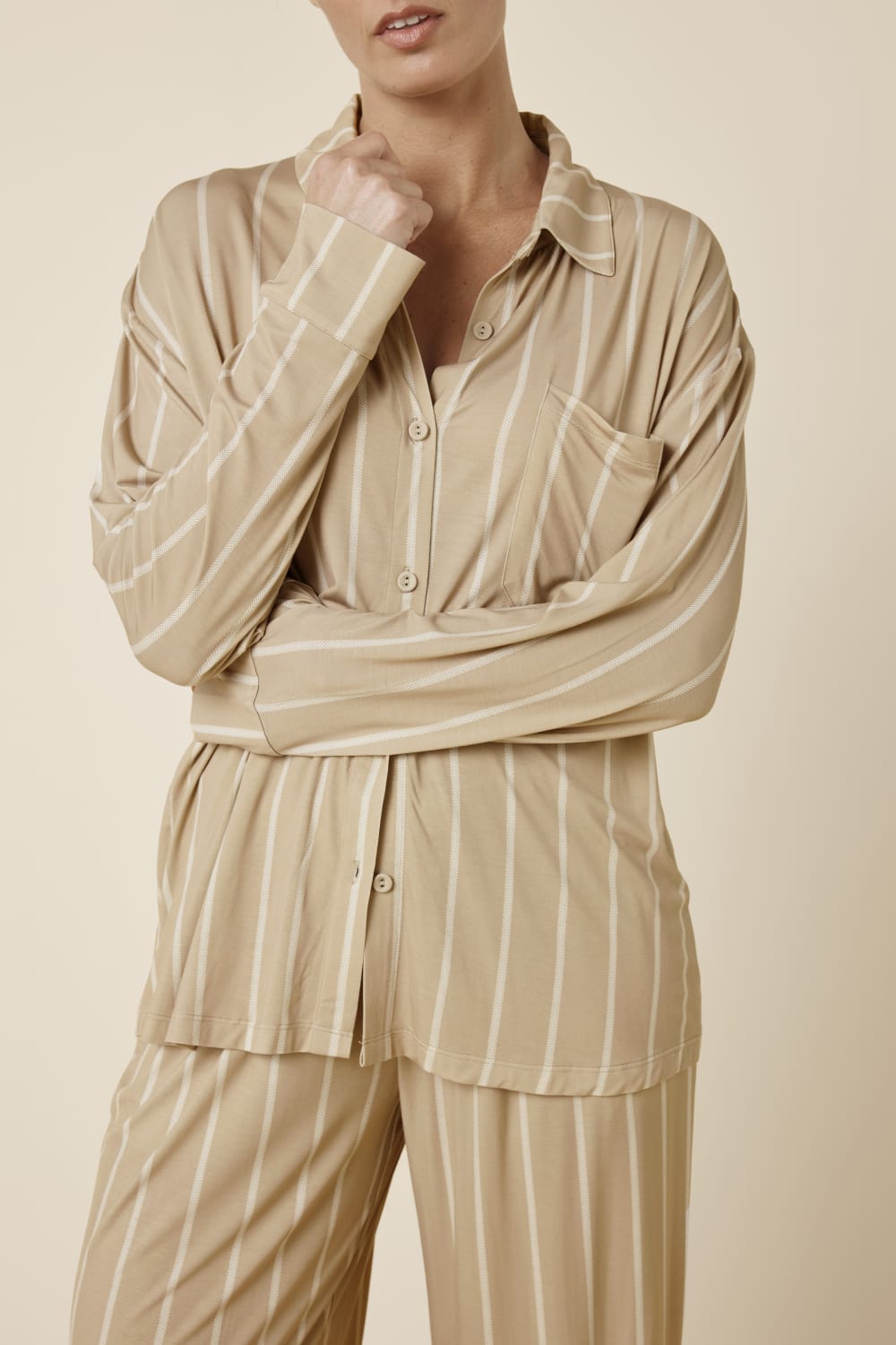 Woman wearing the Biscuit Harlow Bamboo Striped PJ Set biscuit front view cropped showing buttons and white stripes
