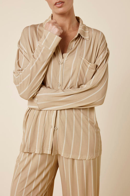 Woman wearing the Biscuit Harlow Bamboo Striped PJ Set biscuit front view cropped showing buttons and white stripes