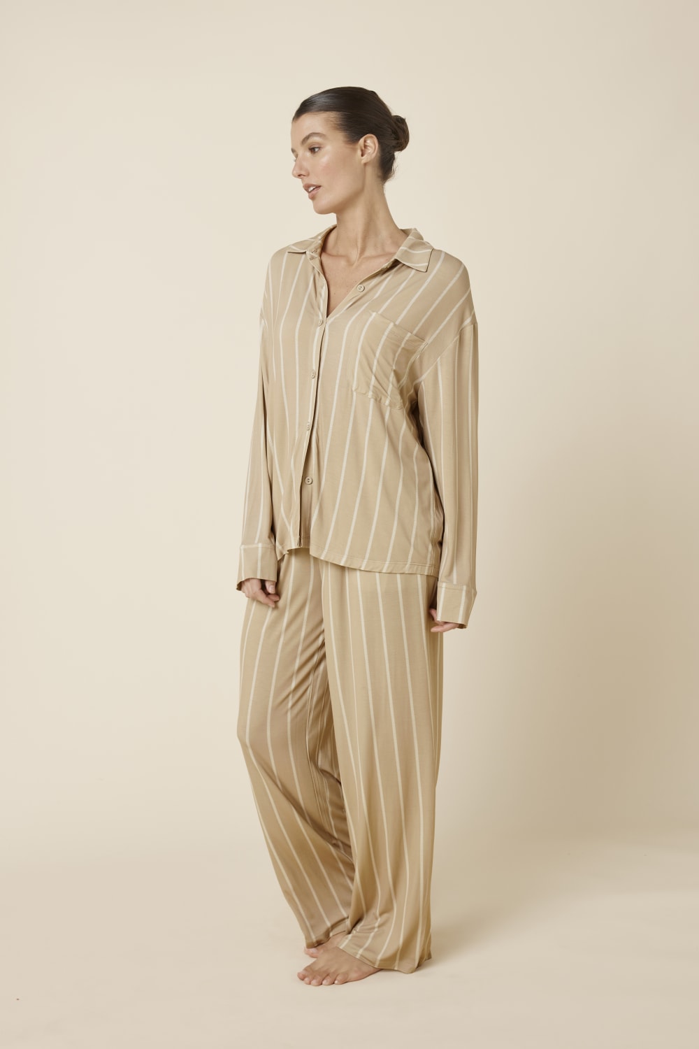 Woman wearing a Harlow Bamboo Striped pyjama PJ Set biscuit from side on view