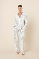 Woman wearing the Harlow Bamboo Striped PJ Set Ivory front view with hands in pockets