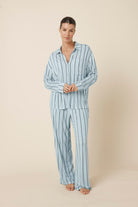 Woman wearing a light blue Harlow Bamboo Striped pyjama PJ Set from a front on view with hands together