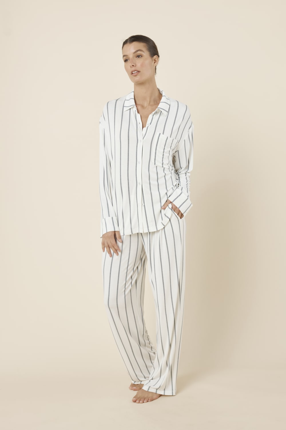Woman wearing a white ivory Harlow Bamboo Striped PJ Set with one hand in pocket side on view