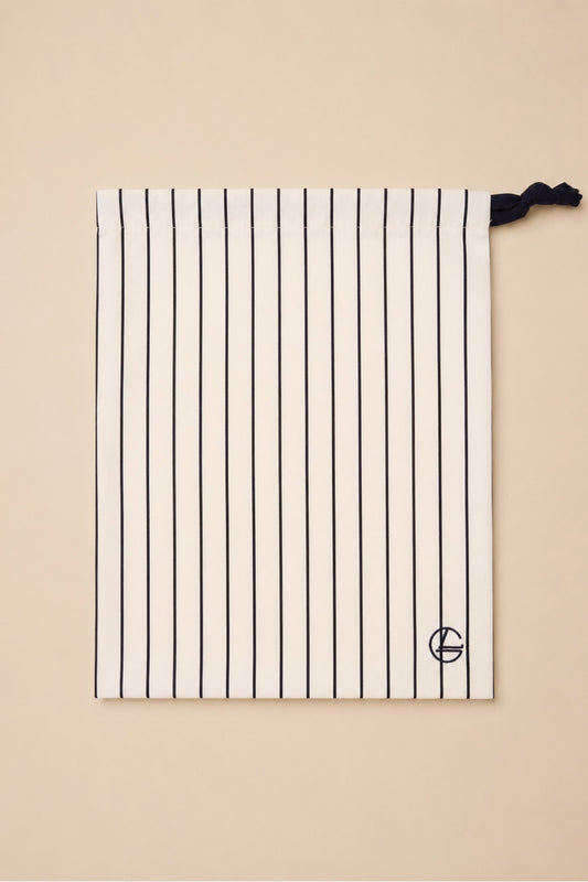 Willow Cotton Stripe PJ Set in Ivory, close-up of its matching ivory striped drawstring bag