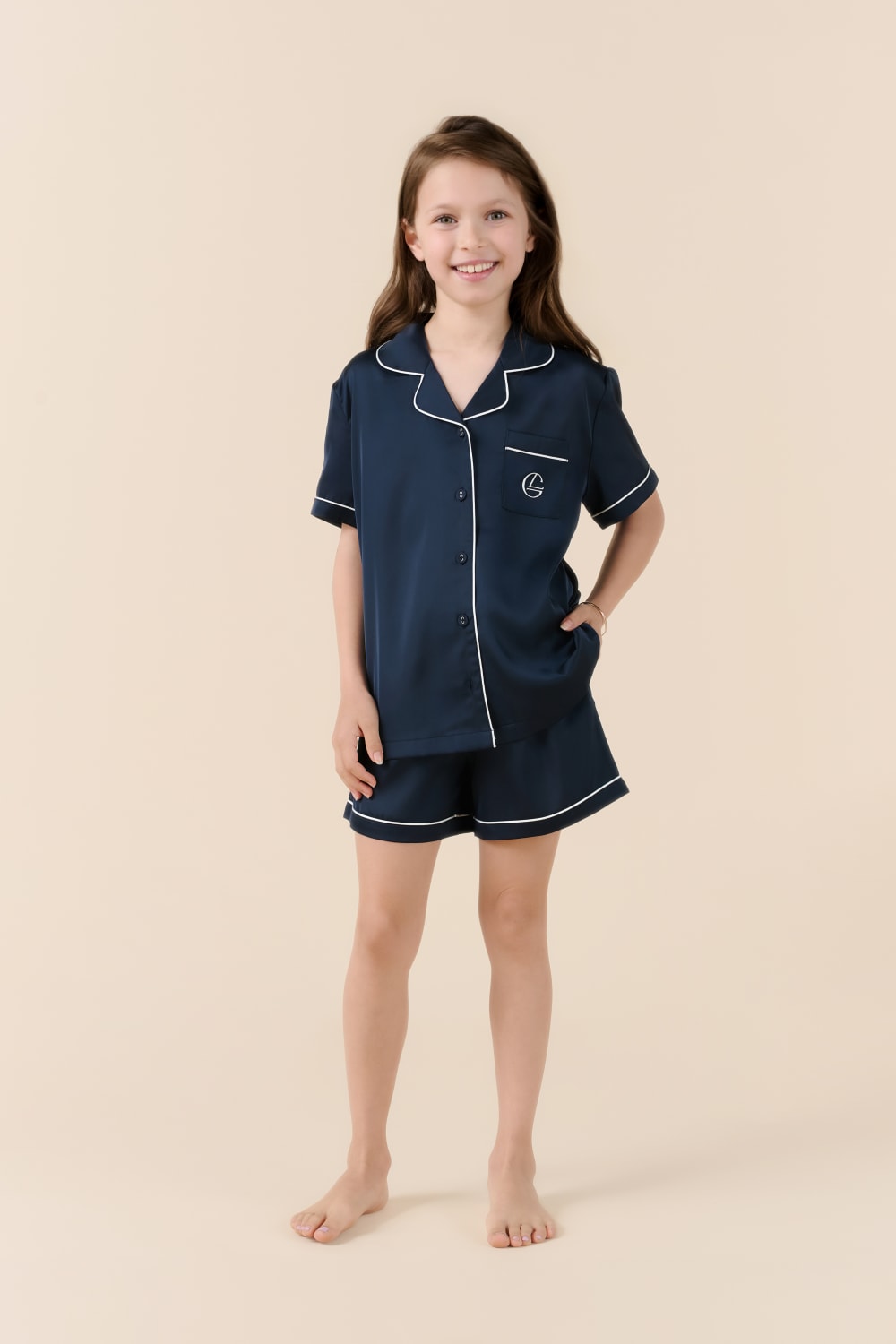 Girl wearing navy blue Gingerlilly Sleepwear short pajama set with white trim