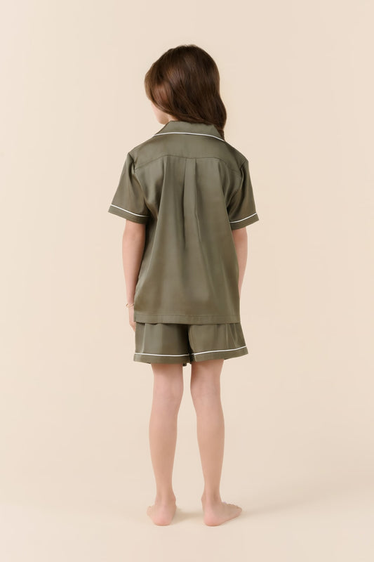 Child in olive green Gingerlilly Sleepwear short pajama set, back view, on beige background