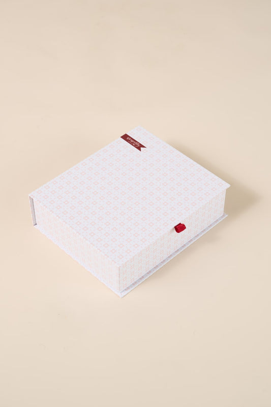 Pink patterned Gingerlilly Sleepwear gift box on a beige background