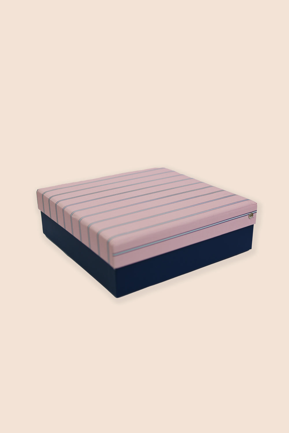 Box spring with pink and blue striped top and navy base on a beige background