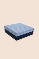 Blue and navy striped mattress on a beige background