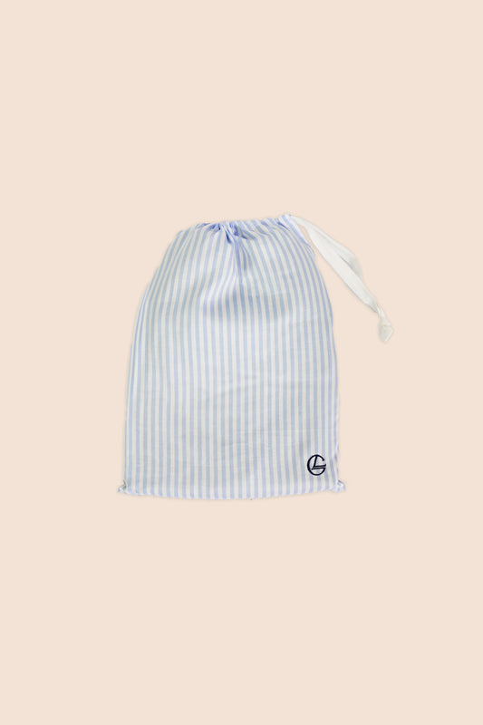 Gingerlilly Sleepwear blue and white striped fabric drawstring bag on beige background