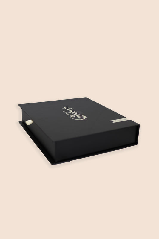 Gingerlilly Sleepwear black gift box with logo on beige background