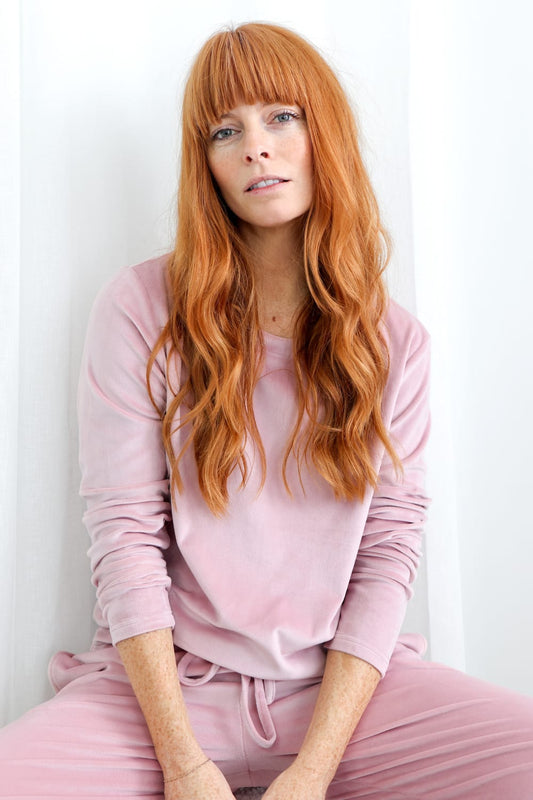 Woman wearing soft pink Gingerlilly Sleepwear lounge set, natural light, casual look