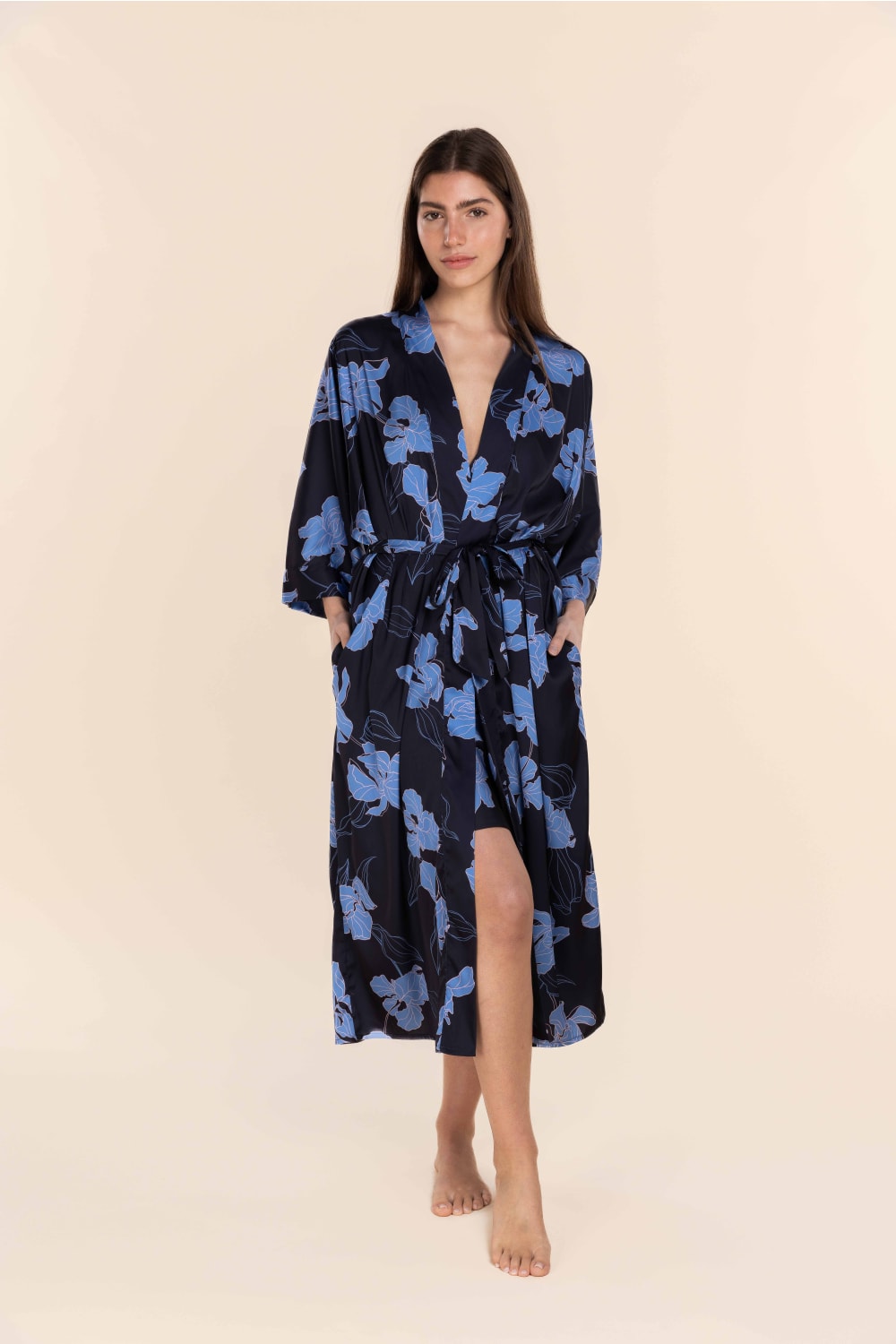 Woman wearing a blue floral patterned robe on a beige background