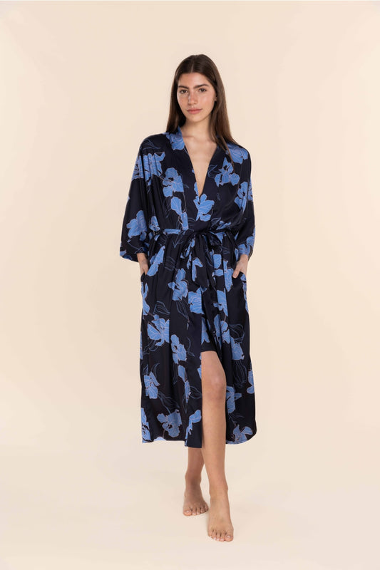 Woman wearing a blue floral patterned robe on a beige background