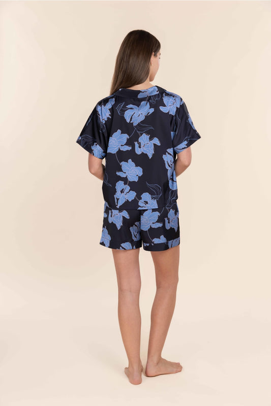 Woman wearing Gingerlilly Sleepwear navy floral short pyjama set, back view.