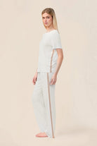 Woman wearing the Bronte Bamboo T-Shirt with Stripe in Ecru, side view