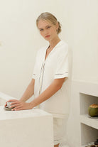 Woman wearing the Helena Short Bamboo PJ Set in Ecru, lifestyle view