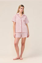 Woman wearing the Poppy Stripe Short PJ Set in Pink, front view of short sleeve shirt and shorts