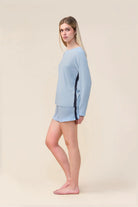Woman wearing the Solene Long Sleeve Top with Stripe in Blue, side view