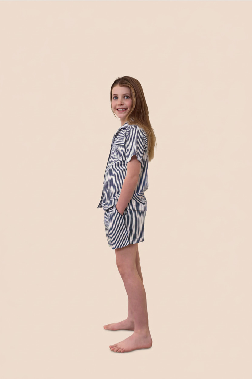 Young girl wearing a striped outfit on a beige background