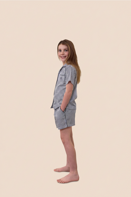 Young girl wearing a striped outfit on a beige background