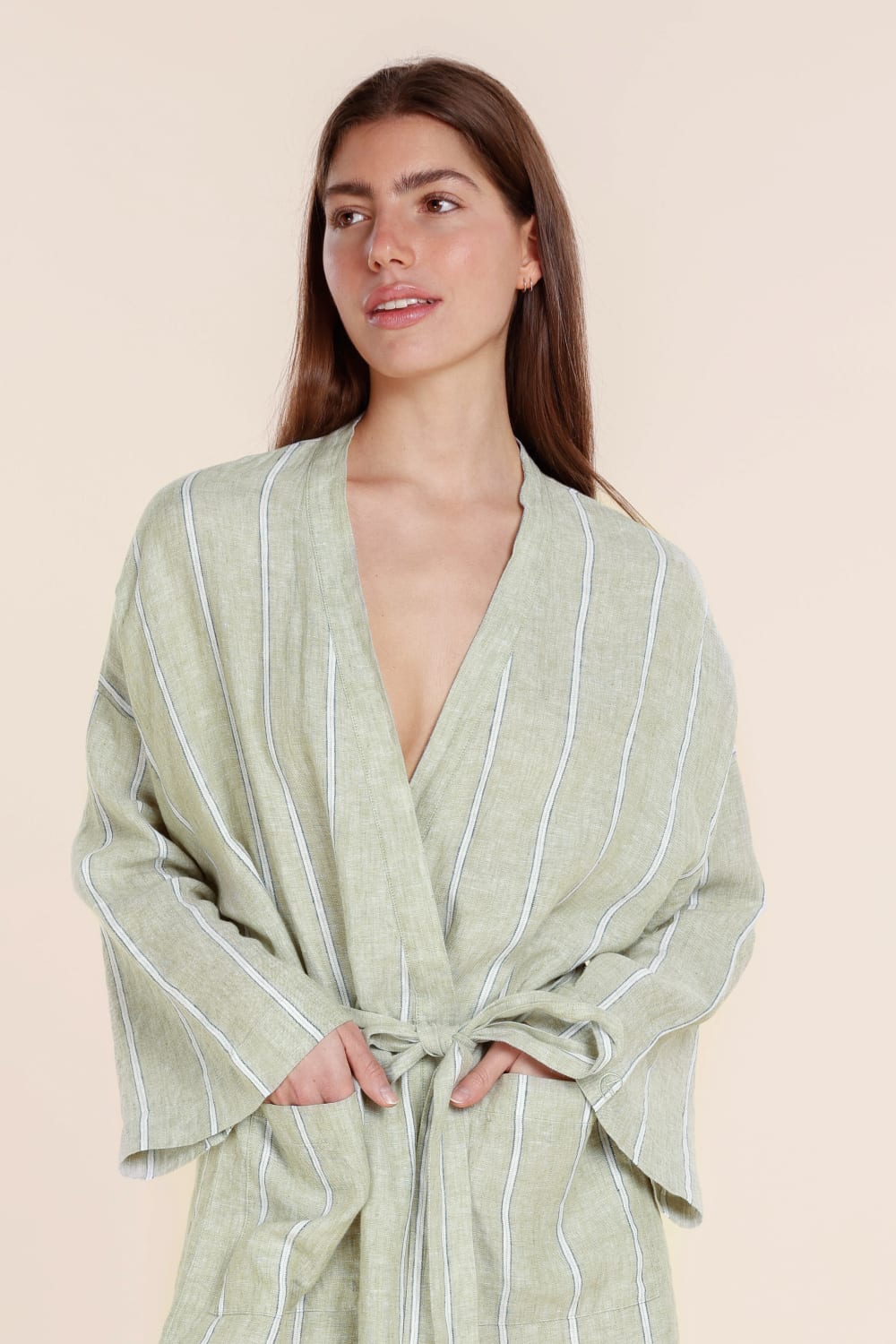 Woman wearing a Gingerlilly Sleepwear olive stripe robe made from natural fabric, front tie