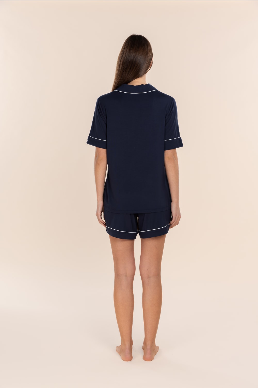 Woman wearing the Sadie Bamboo Short PJ Set in Navy, back view