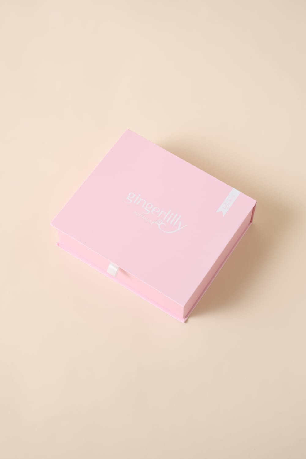 Gingerlilly Sleepwear pink gift box on beige background, Australian natural fabrics
