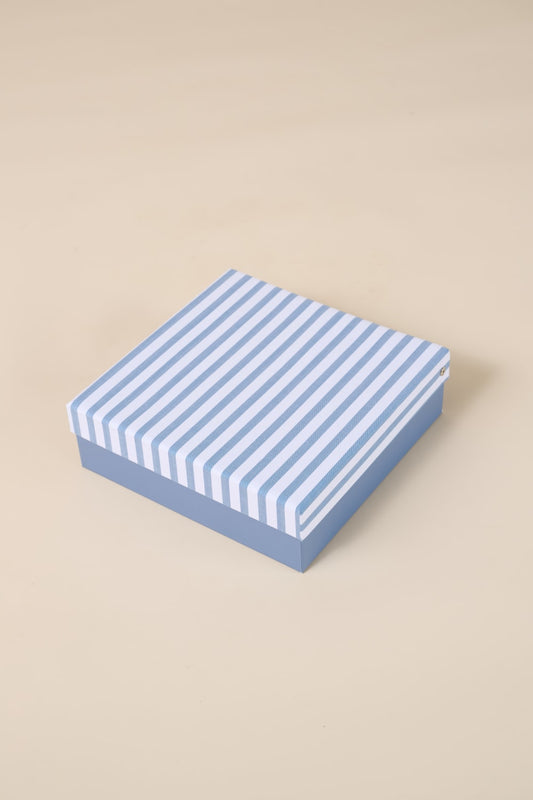 Blue and white striped Gingerlilly Sleepwear gift box on beige background