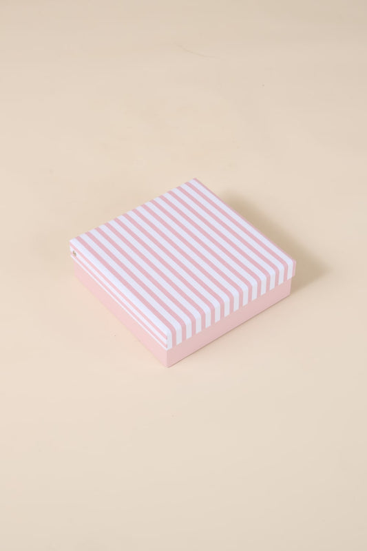 Pink and white striped Gingerlilly Sleepwear gift box on beige background